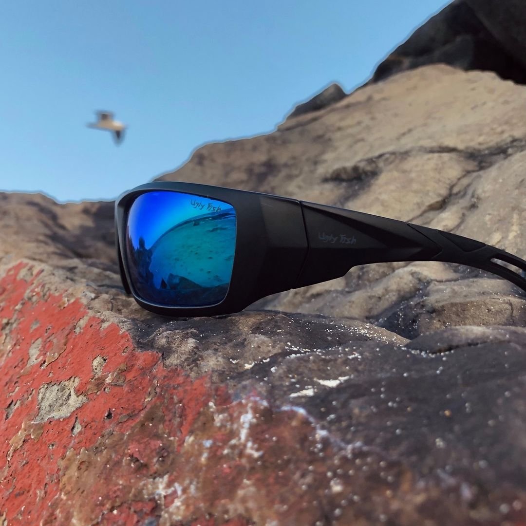 Polarised mirror safety sunglasses with a wrap around frame and blue lenses.