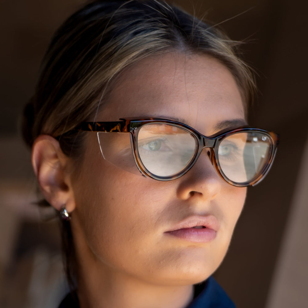 Person wearing Ugly Fish Safety glasses with a blurred background