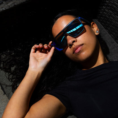 Person wearing Sage Retro sunglasses in a dark setting
