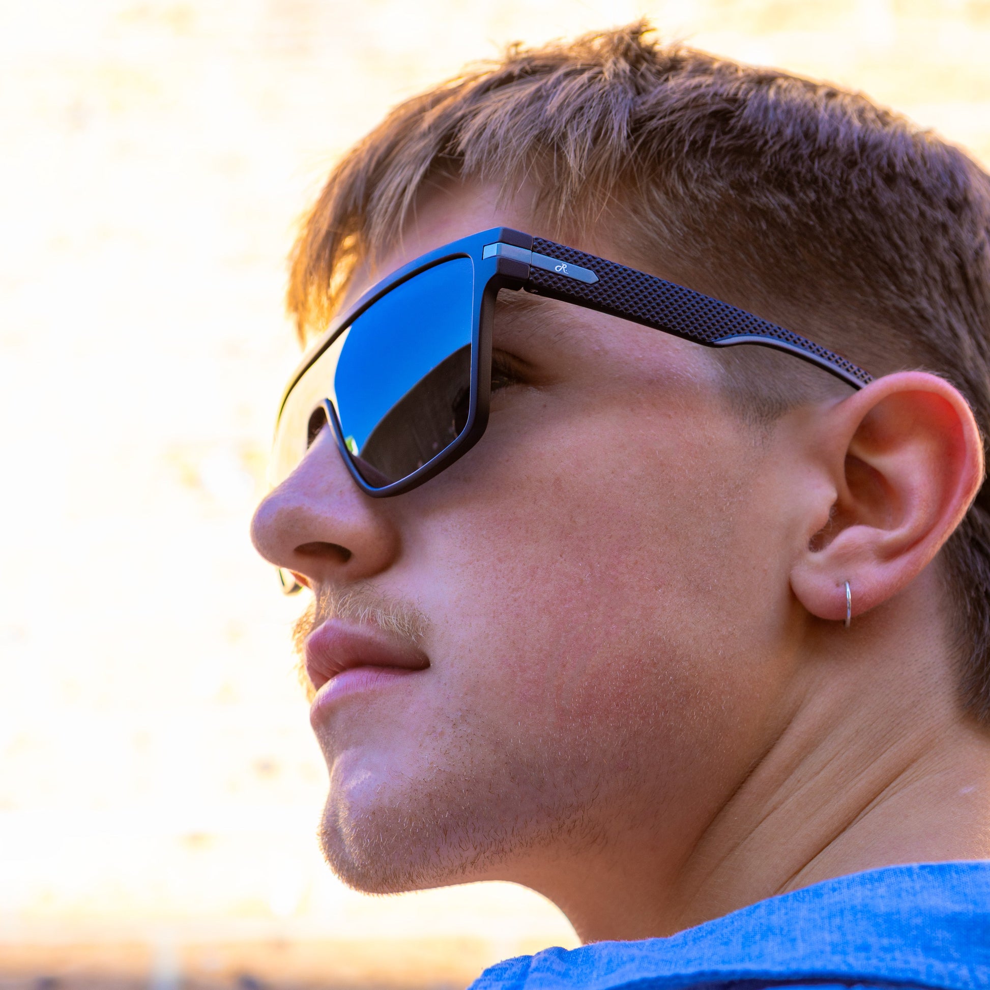 Person wearing Sage Retro reflective sunglasses with a blurred background