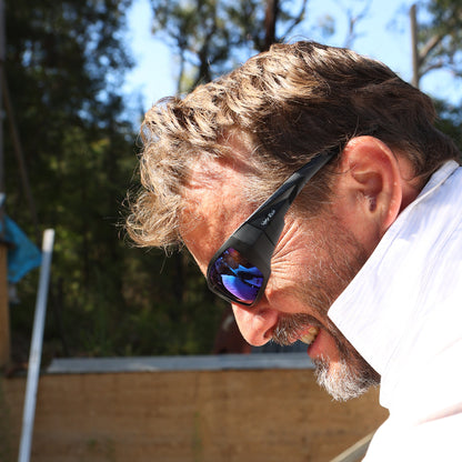 Man wearing Ugly Fish Safety sunglasses with a blurred background