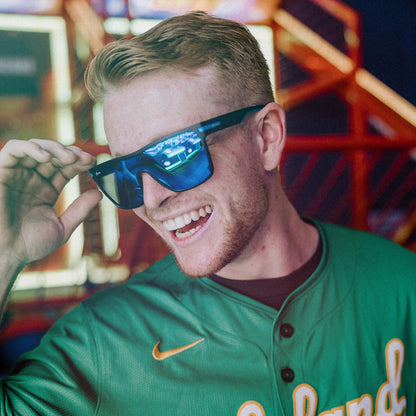 Man wearing Sage Retro sunglasses indoors.