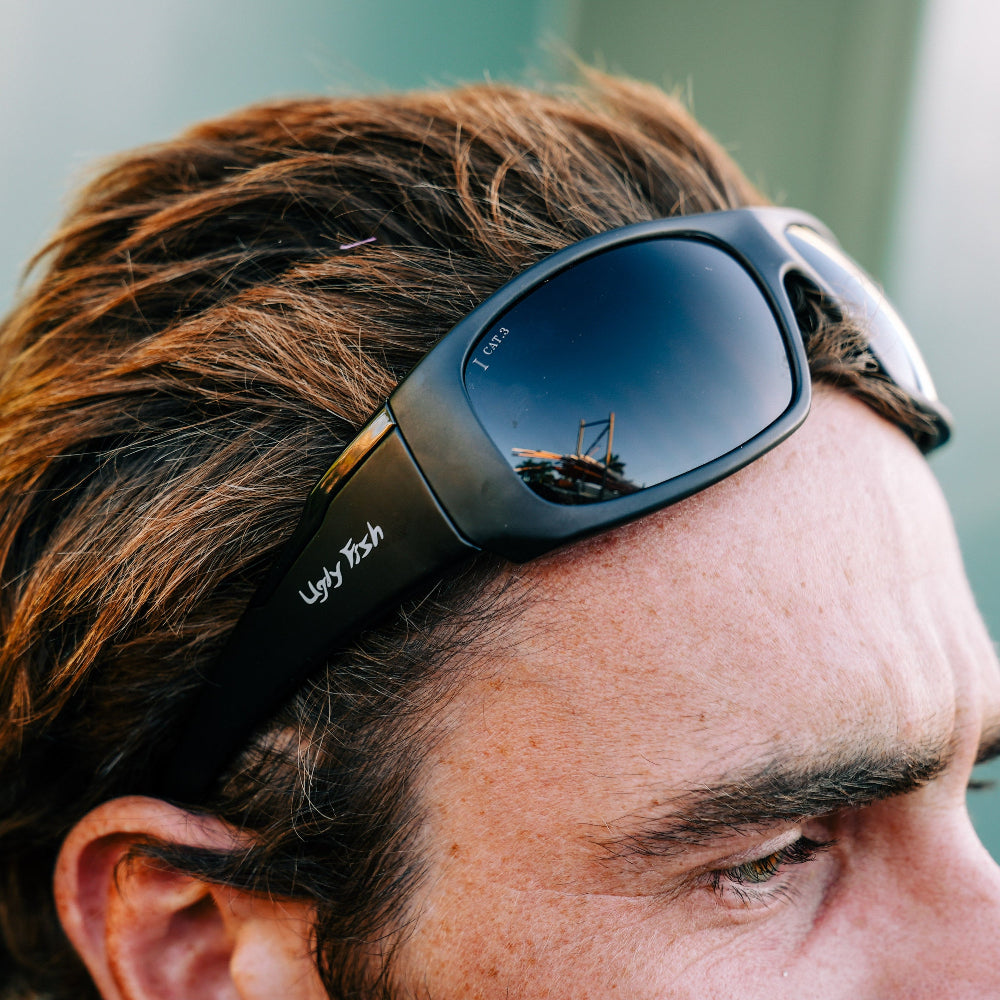 Person wearing Ugly Fish Safety sunglasses on head.