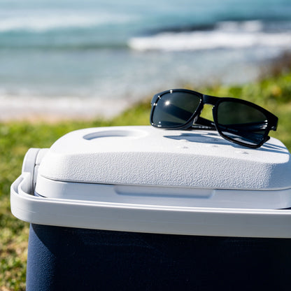 Ugly Fish unbreakable sunglasses on a cooler with a beach in the background